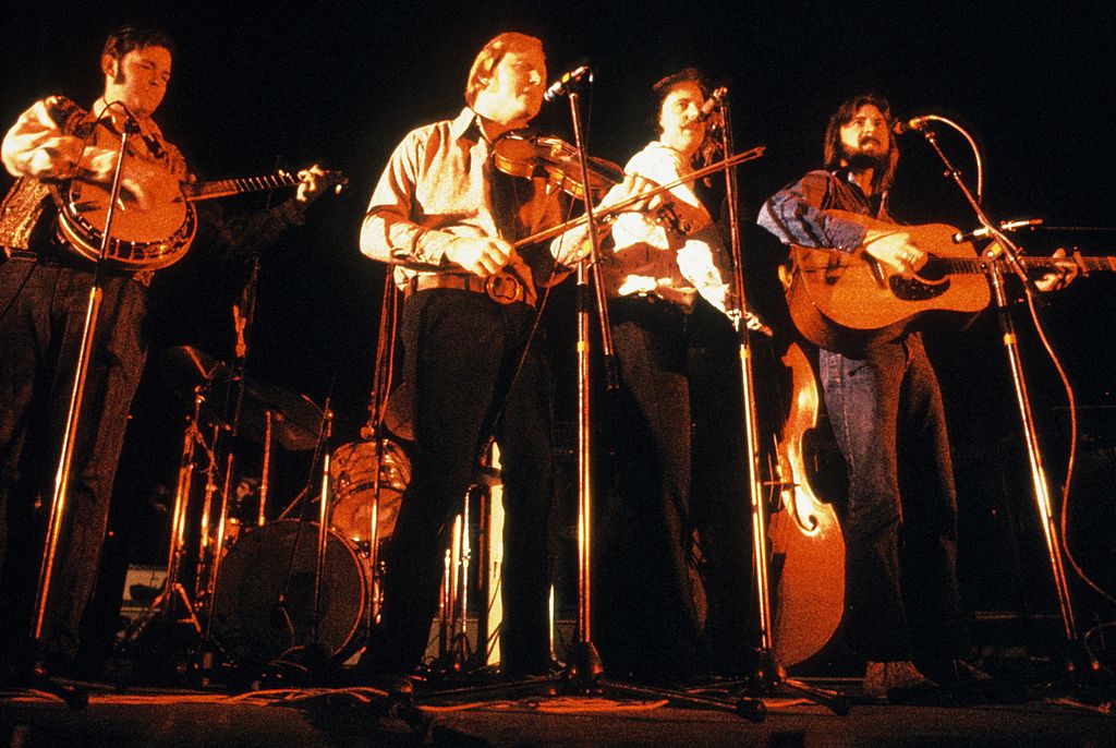 Alan Munde, Byron Berline, Roger Bush and Kenny Wertz of the Flying Burrito Brothers perform on stage in 1973 in Amsterdam, Netherlands. (Photo by Gijsbert Hanekroot/Redferns)