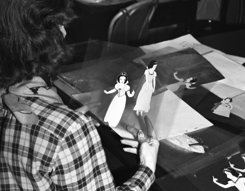 archival footage of an animator coloring cels for walt disney's snow white and the seven dwarfs in 1937