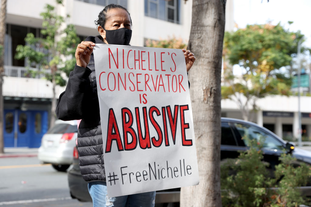 Supporter holds a sign at a rally for actress and civil rights activist Nichelle Nichols to free her from her conservatorship at Stanley Mosk Courthouse on January 10, 2022 in Los Angeles, California. 