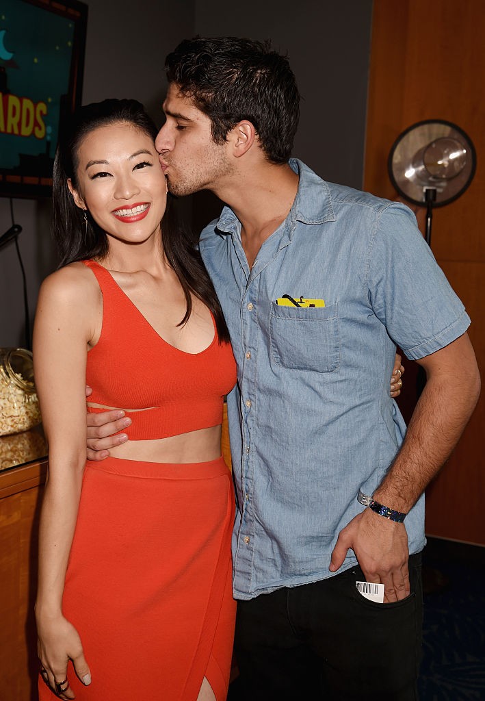 Actors Arden Cho (L) and Tyler Posey attend The 2015 MTV Movie Awards at Nokia Theatre L.A. Live on April 12, 2015 in Los Angeles, California.