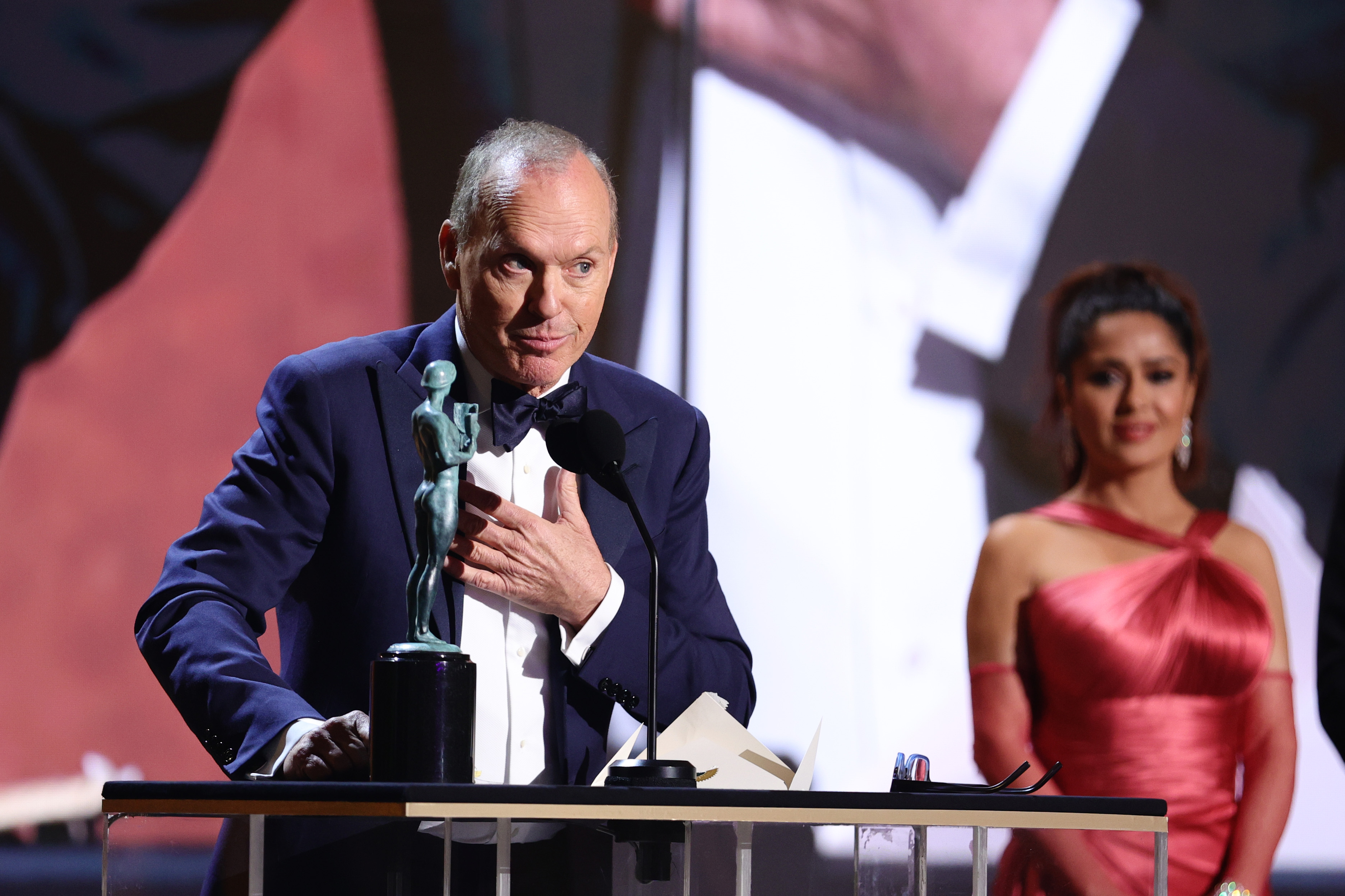 Michael Keaton accepts the Outstanding Performance by a Male Actor in a Television Movie or Limited Series award for ’Dopesick’ onstage during the 28th Screen Actors Guild Awards at Barker Hangar