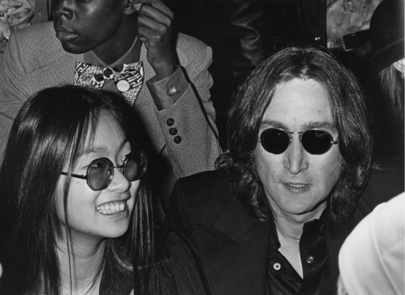 Ex-Beatle John Lennon (1940 - 1980) and his girlfriend May Pang, his former secretary, at the opening of 'Sergeant Pepper's Lonely Hearts Club Band on the Road' on Broadway, New York City, 21st November 1974. 
