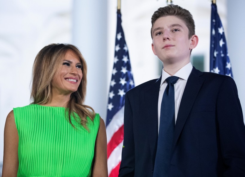 First lady Melania Trump (L) looks at her son Barron Trump 