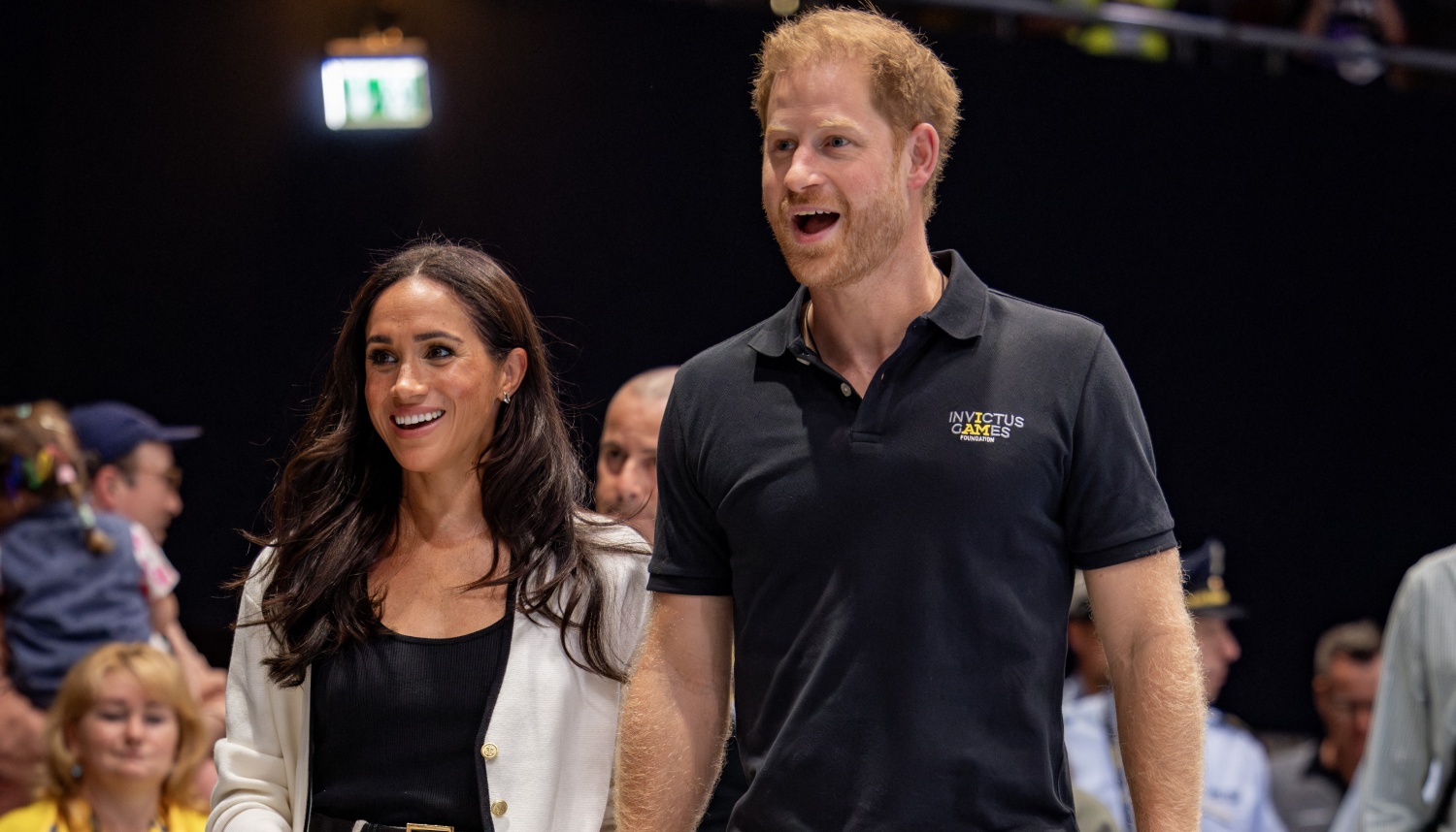 Meghan Markle, Duchess of Sussex (L) and Britain's Prince Harry, Duke of Sussex