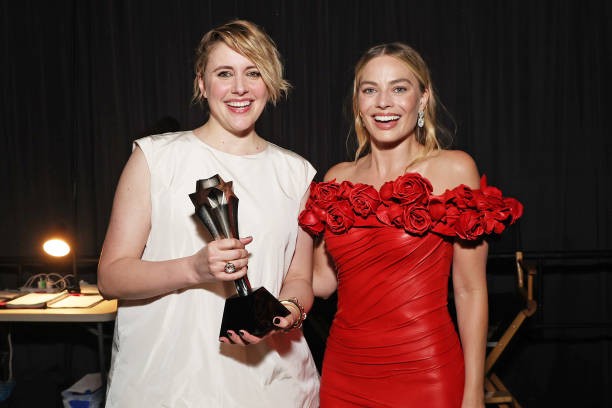 SANTA MONICA, CALIFORNIA - JANUARY 14: (L-R) Greta Gerwig and Margot Robbie, winners of the Best Comedy Award for 'Barbie,' pose backstage during the 29th Annual Critics Choice Awards at Barker Hangar on January 14, 2024 in Santa Monica, California.