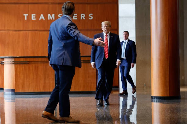 WASHINGTON, DC - JANUARY 31: Republican presidential candidate and former U.S. President Donald Trump (C) walks to a podium to deliver remarks after meeting with leaders of the International Brotherhood of Teamsters at their headquarters on January 31, 2024 in Washington, DC. The United Auto Workers endorsed President Joe Biden's re-election campaign one week ago.