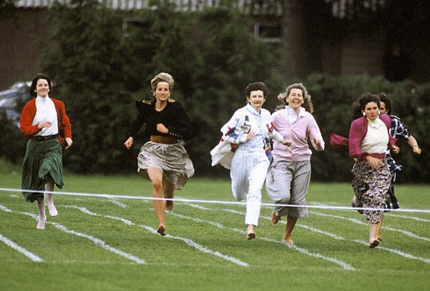LONDON, ENGLAND - JUNE 11: Diana, Princess of Wales, runs barefoot as she takes part in the Mother's race during Prince Harry's school sports day in Richmond on June 11, 1991 in London, United Kingdom.