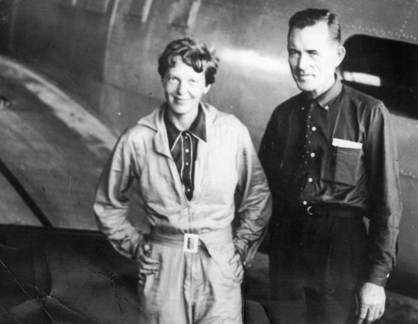 11th June 1937: : American aviatrix Amelia Earhart (1897 - 1937) with her navigator, Captain Fred Noonan, in the hangar at Parnamerim airfield, Natal, Brazil, 11th June 1937. Together they are attempting a circumnavigation of the globe. (Photo by Topical Press Agency/Getty Images)