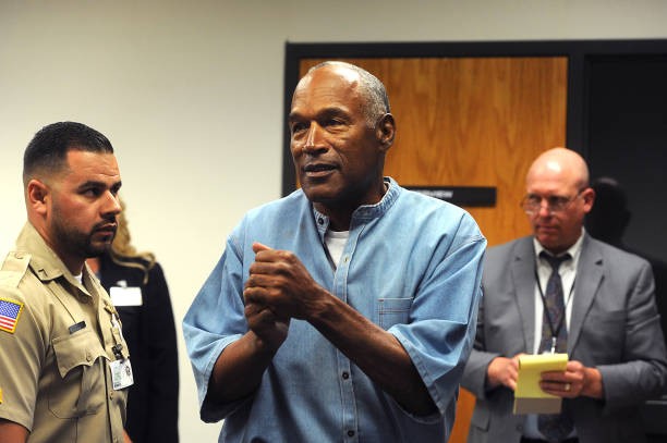 LOVELOCK, NV - JULY 20: O.J. Simpson (C) reacts after learning he was granted parole at Lovelock Correctional Center July 20, 2017 in Lovelock, Nevada. Simpson is serving a nine to 33 year prison term for a 2007 armed robbery and kidnapping conviction.