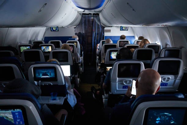 Passengers on a Boeing 737 Max-8 plane during a United Airlines flight departing from Newark Liberty International Airport (EWR) in Newark, New Jersey, US, on Wednesday, March 13, 2024. The TSA expects travel volumes during the peak spring break travel season at nearly 6% above 2023. 