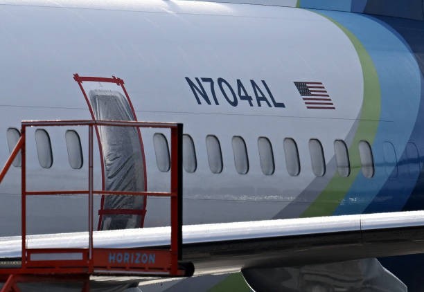 The missing emergency door of Alaska Airlines N704AL, a 737 Max 9, which made an emergency landing at Portland International Airport on January 5 is covered and taped, in Portland, Oregon on January 23, 2024. 