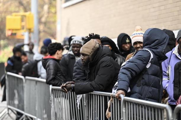 NEW YORK CITY, UNITED STATES - DECEMBER 4: Asylum seekers line up in front of the East Village re-intake, converted into a city-run shelter for newly arrived migrant families in New York City, United States on December 4, 2023. 