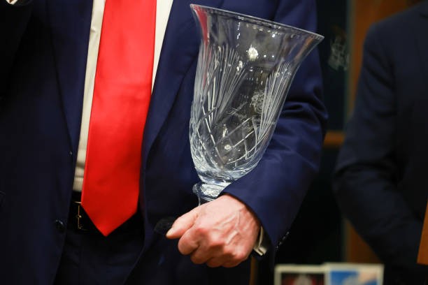 WEST PALM BEACH, FLORIDA - MARCH 24: Republican presidential candidate and former President Donald Trump holds the 2024 Trump International Golf Club Most Improved Player award given to him on March 24, 2024, in West Palm Beach, Florida. Donald Trump is expected to be in New York in the morning for a court appearance in his Manhattan criminal prosecution case.