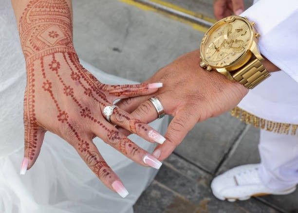 LAS VEGAS, NEVADA - DECEMBER 31: Priti Pouncy (L) and Terrence Pouncy of Illinois display their wedding rings after getting married at the Little White Wedding Chapel on December 31, 2023 in Las Vegas, Nevada. 