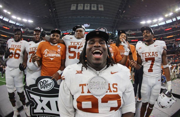 ARLINGTON, TX - DECEMBER 2: Defensive lineman T'Vondre Sweat #93 of the Texas Longhorns celebrates with teammates after Texas defeated the Oklahoma State Cowboys in the Big 12 Championship at AT&T Stadium on December 2, 2023 in Arlington, Texas. 