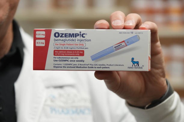 A pharmacist holds a box of Novo Nordisk A/S Ozempic brand semaglutide medication arranged at a pharmacy in Provo, Utah, US, on Monday, Nov. 27, 2023. Prescriptions of appetite suppressing GLP-1 weight-loss drugs skyrocketed 300% from 2020 to 2022.