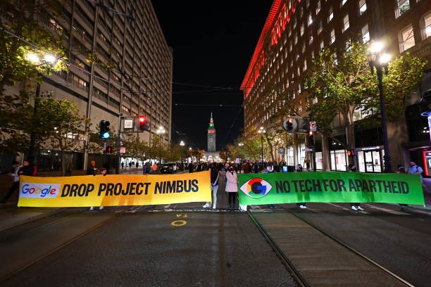 SAN FRANCISCO, CALIFORNIA - DECEMBER 14: Hundreds of protestors including Google workers are gathered in front of Google's San Francisco offices and shut down traffic at One Market Street block on Thursday evening, demanding an end to its work with the Israeli government, and to protest Israeli attacks on Gaza, in San Francisco, California, United States on December 14, 2023. 