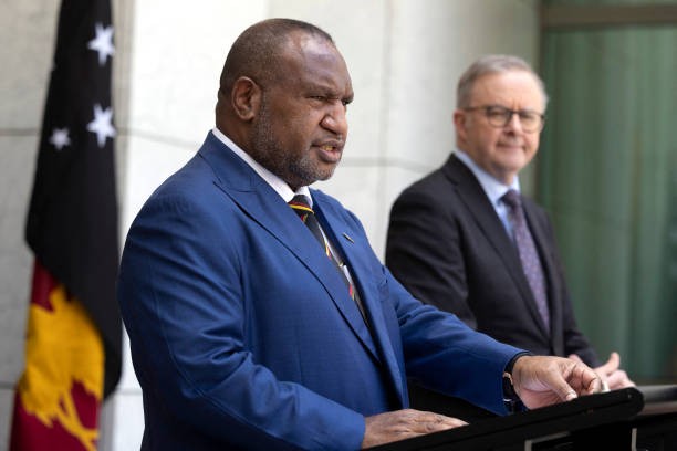 Papua New Guinea's Prime Minister James Marape speaks as Australia's Prime Minister Anthony Albanese (R) looks on during a press conference at Parliament House in Canberra on December 7, 2023. Australia signed a security deal with Papua New Guinea on December 7, bolstering ties to a key Pacific neighbour that has been courted persistently by China.