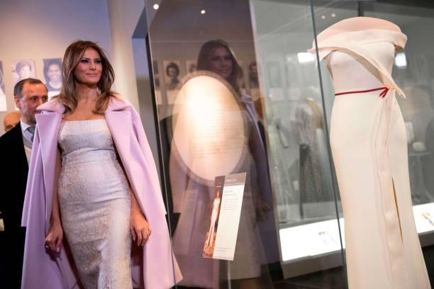 US First Lady Melania Trump stands alongside the gown she wore to the 2017 inaugural balls as she donates the dress to the Smithsonian's First Ladies Collection at the Smithsonian National Museum of American History in Washington, DC, October 20, 2017. / AFP PHOTO / SAUL LOEB.
