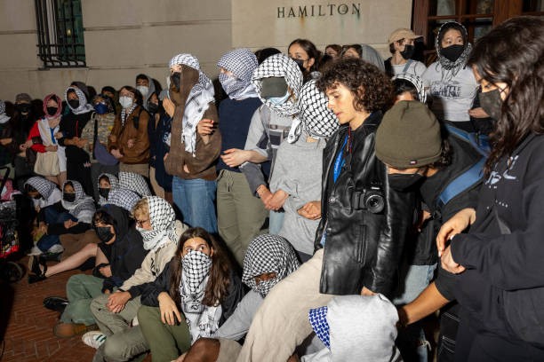 NEW YORK, NEW YORK - APRIL 29: Students/demonstrators lock arms to guard potential authorities against reaching fellow protestors who barricaded themselves inside Hamilton Hall, an academic building which has been occupied in past student movements,, and name it after a Palestinian child allegedly killed by the Israeli military on Tuesday, April 30, 2024 in New York City. 