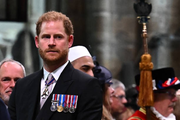 TOPSHOT - Britain's Prince Harry, Duke of Sussex looks on as Britain's King Charles III leaves Westminster Abbey after the Coronation Ceremonies in central London on May 6, 2023