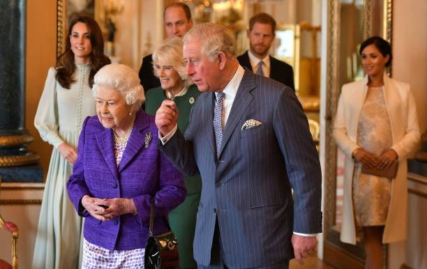 TOPSHOT - Britain's Prince Charles, Prince of Wales (C) walks with his mother Britain's Queen Elizabeth II (2L), and his wife Britain's Camilla, Duchess of Cornwall (3L), and his sons and their wives, Britain's Prince William, Duke of Cambridge (4L) and Britain's Catherine, Duchess of Cambridge (L), and Britain's Prince Harry, Duke of Sussex, (2R) and Meghan, Duchess of Sussex (R) during a reception to mark the 50th Anniversary of the investiture of The Prince of Wales at Buckingham Palace in London on March 5, 2019.