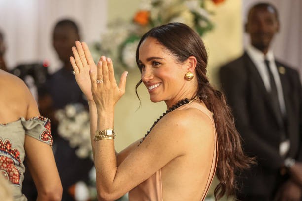 Britain's Meghan, Duchess of Sussex, gestures as she arrives with Britain's Prince Harry (unseen), Duke of Sussex, during their visit at the Lightway Academy in Abuja on May 10, 2024 as they visit Nigeria as part of celebrations of Invictus Games anniversary. 