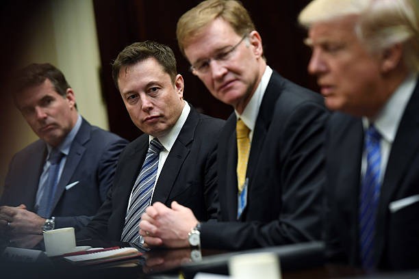 WASHINGTON, DC - JANUARY 23: Elon Musk, left center, and Wendell P. Weeks, right center, listen to President Donald Trump, right, as he meets with business leaders at the White House on Monday January 23, 2017.