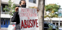 Supporter holds a sign at a rally for actress and civil rights activist Nichelle Nichols to free her from her conservatorship at Stanley Mosk Courthouse on January 10, 2022 in Los Angeles, California. 